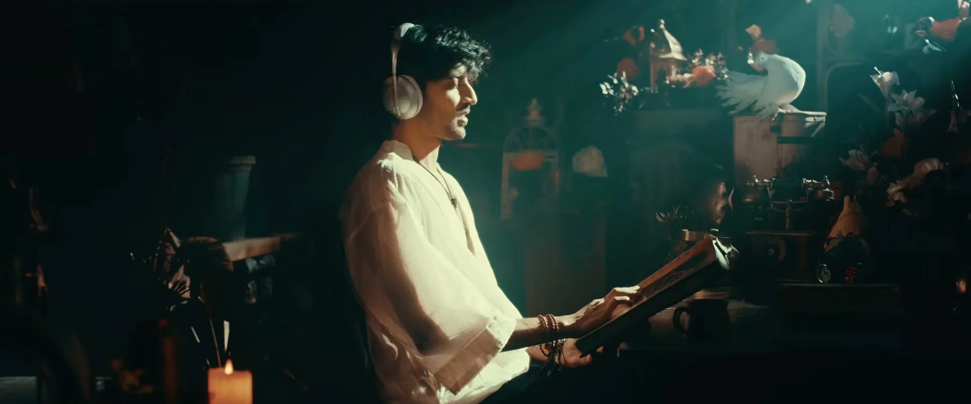Vivasvaan with headphones and a book in an ornate room